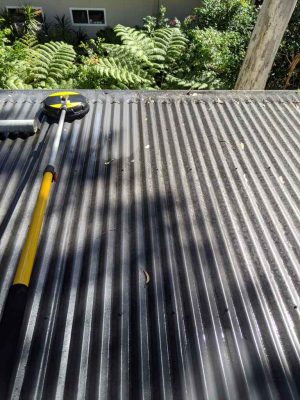 A high-pressure surface washer is used to clean this roof at Murray's Beach