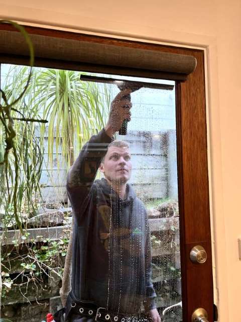 A man cleaning a window