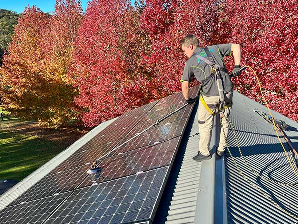 Micah is cleaning a solar panel system with our carbon-fibre water fed pole and soft-bristled brush.
